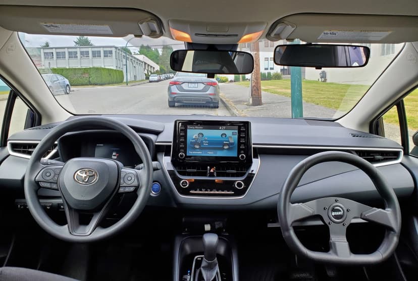 Dual steering wheel setup showing instructor controls
