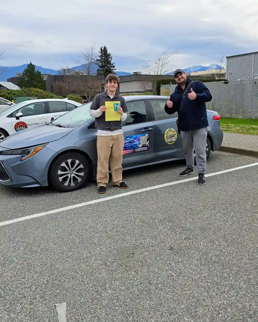 Jason Hildebrandt review photo showing road test success beside the Right of Way driving school car