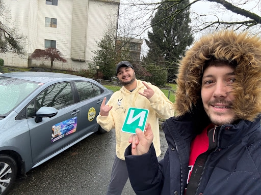 Mucahit Mert Alagoz celebrating with an N sign next to the Right of Way training car